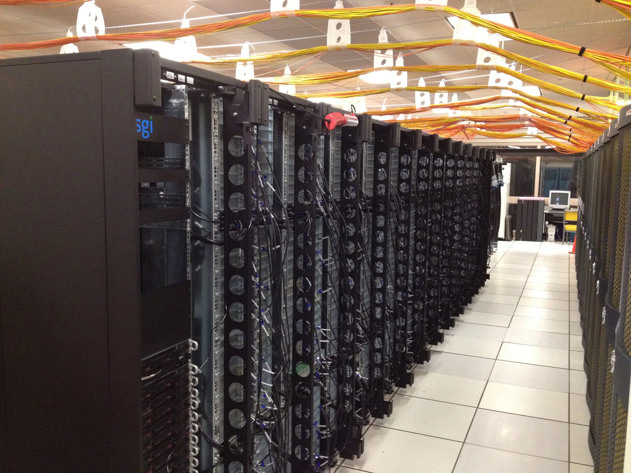 Internal computing racks and overhead cabling of NASA’s Pleiades supercomputer, pictured during its 2012 upgrade.